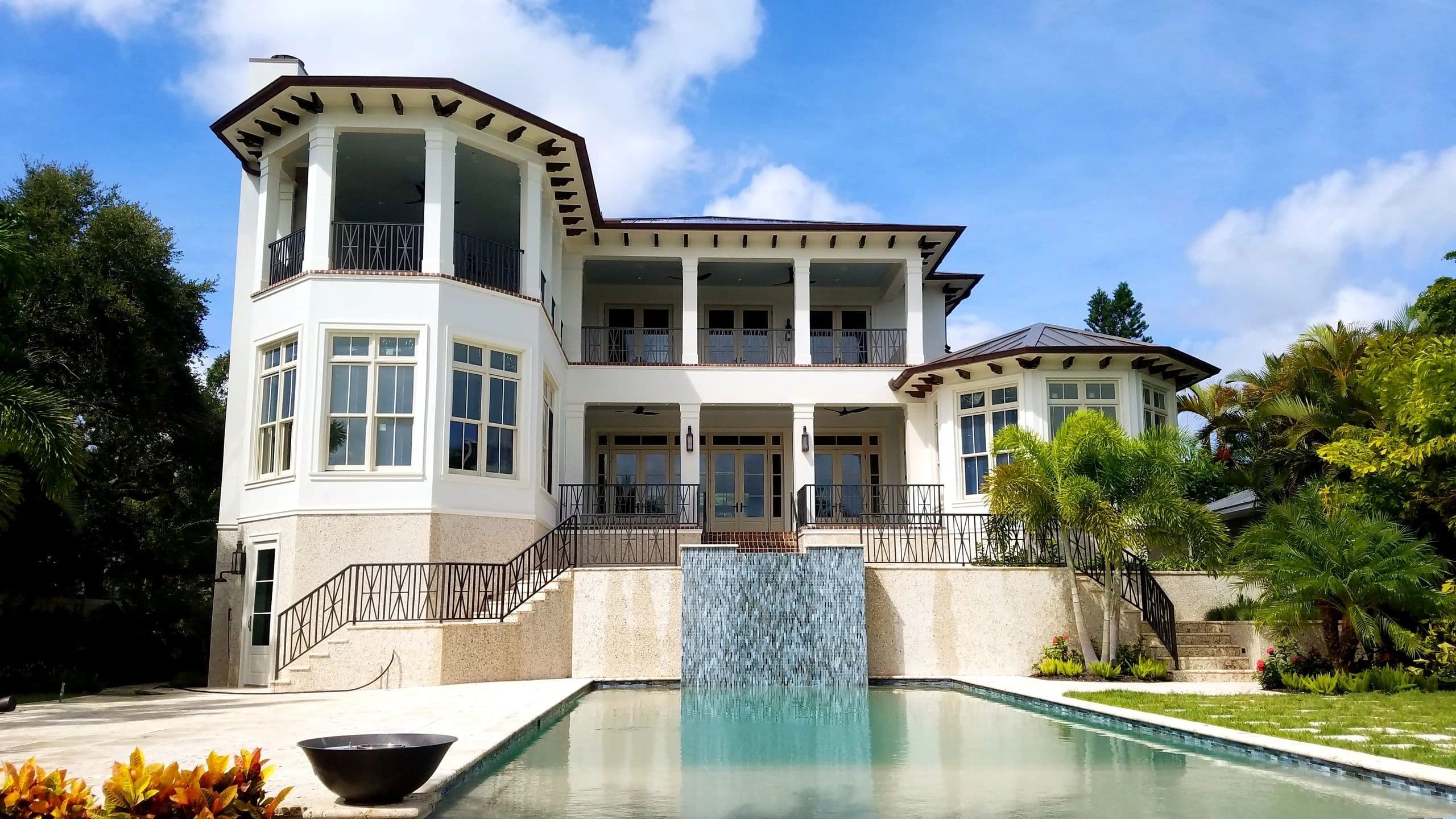 A Sarasota property Pressure Perfect maintains: white stucco, terracotta roofline, pool deck